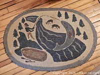 Full view of oval rug showing entire fisherman and fish design