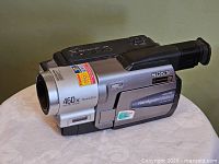 Left-front view showing lens, labels and overall body