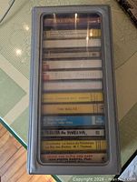 Closed case showing cassette spines through clear lid