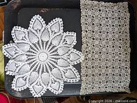 Round starburst doily next to rectangular lace panel on tray