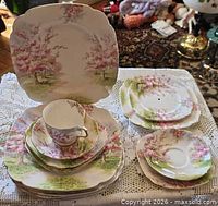 Group shot showing cup, saucer, stacks of square and round plates