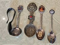 Front view of all five spoons showing decorative tops and bowls