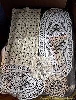 Overview of all five lace pieces displayed flat