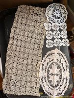 All four lace pieces laid out on dark tray