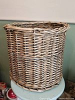 Front and side view of wicker waste basket