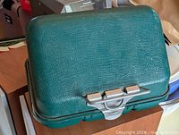 Closed green UMCO tackle box showing exterior and latch