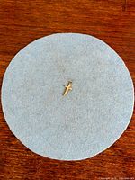 Full view of crucifix pendant on felt background