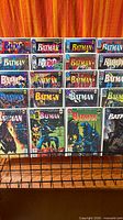 Front view of all 18 bagged Batman issues on rack