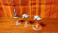 Front view of three metal miniatures on flight stands