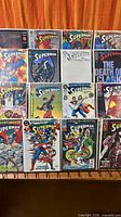 Front view of 15 bagged Superman comics arranged in three rows