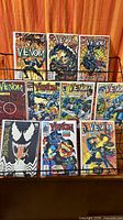 Full rack view showing 11 bagged Venom comics