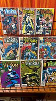 Rack with nine bagged Venom comics showing three mini-series