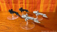 Four Dauntless Light Cruiser miniatures on stands