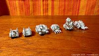 Full lineup of six unpainted pewter Warhammer 40K vehicles