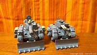 Front view of two unpainted Leman Russ tanks with dozer blades