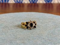 Ring front view showing marquise sapphire cluster and diamond halo