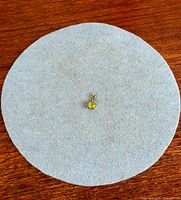 Pendant centered on blue felt for full view