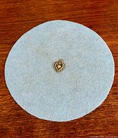 Pendant on grey felt circle