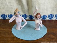 Both bisque half dolls front view on blue felt