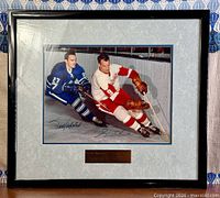 Full view of framed autographed photo showing mat and plaque