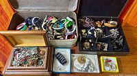 Overall view of multiple boxes filled with assorted jewelry pieces