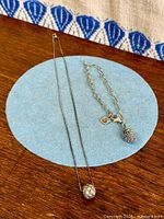 Necklace and bracelet on blue circle background