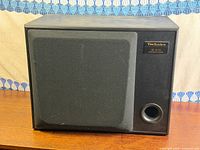 Front view showing grill, port and model badge