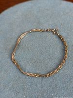 Full view of sterling silver bracelet laid flat to show entire chain and clasp