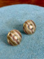 Front view of both round tri-colour gold earrings