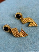 Both earrings front view on fabric