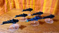 Five painted starship miniatures on stands