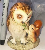 Front view of Beswick Beatrix Potter Old Mrs. Brown owl and squirrel figurine beside marker for scale