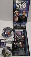 Front view of Doctor Who Time of the Daleks Seventh & Ninth Doctor expansion box open showing sealed miniatures, card decks, token sheet and rule insert