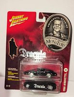Front view of sealed Johnny Lightning Dracula 1969 Firebird diecast car on blister card