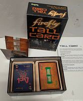 Retail box front, open box showing two 52-card decks, rules sheet