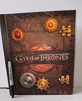 Front cover of hardcover pop-up book with marker for scale