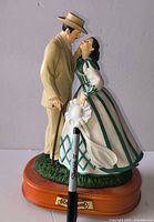 Full view of musical figurine showing characters, base and plaque