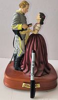Front view of Gone with the Wind figural music box with Sharpie for scale