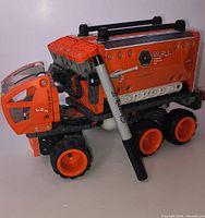 Assembled Hexbug VEX Mobile Lab six-wheel vehicle next to marker for scale