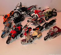 All twelve miniature die-cast motorcycles arranged on tabletop