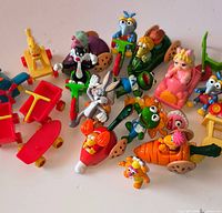 Group shot of all McDonald’s Happy Meal toys displaying characters and vehicles