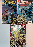 Three Russian Batman comics laid out together