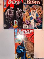 Front covers of three Batman comic books laid out for condition and identification