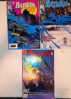 Front covers of all three Batman comics displayed side by side