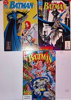 Front covers of the three Batman comic books laid out on flat surface