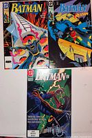 Overview of the three bagged and boarded Batman comic books on a white background showing cover art and condition