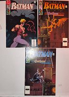 All three Batman comics laid out – Catwoman-style cover upper left, gargoyle cover upper right, gothic tower cover bottom