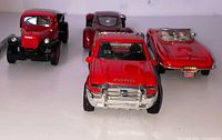 Front view of all four red diecast vehicles