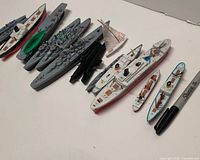 Overview of diecast ships next to Sharpie for scale