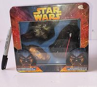 Front view of sealed Star Wars ornament tin showing packaging and visible ornaments